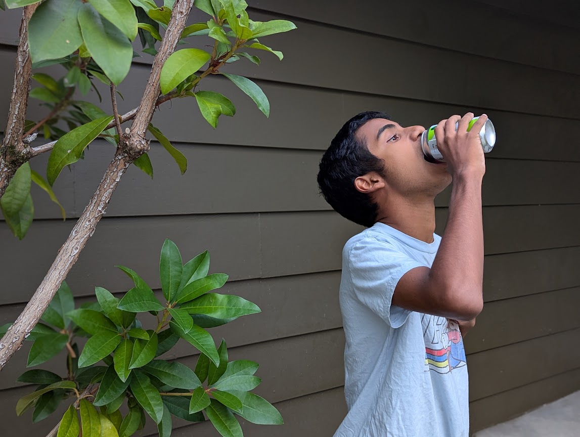 M drinking soda from can